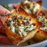 Fresh Mediterranean spinach and feta cheese crisps served warm on a wooden board, ready for an appetizer spread.