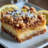 Freshly sliced Homemade Lemon Crumb Bars reveal tangy lemon filling and buttery crumb layers.