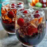 Vibrant rainbow sherbet punch bowl bubbling with Sprite and pineapple juice for festive graduation celebrations.