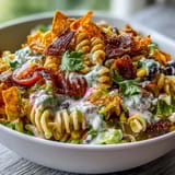 Colorful Taco Pasta Salad with Doritos and Avocado Ranch, featuring zesty taco flavors and a smooth avocado ranch topping.  