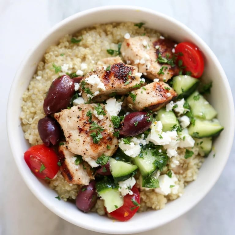 This healthy Mediterranean Chicken Bowl showcases golden grilled chicken, fluffy quinoa, chickpeas, and feta, served in a bright, colorful presentation.
