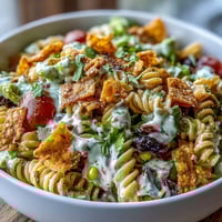 Vibrant Taco Pasta Salad with Doritos and Avocado Ranch, bursting with fresh veggies, crunchy chips, and creamy dressing.  
